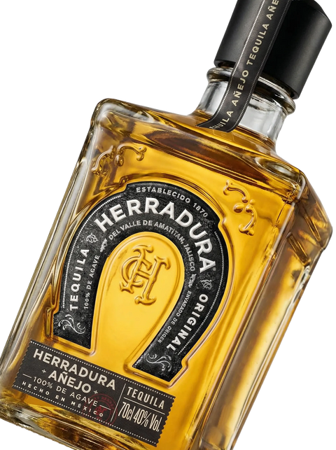 Primer plano de la robusta botella cuadrada de Tequila Herradura Añejo.